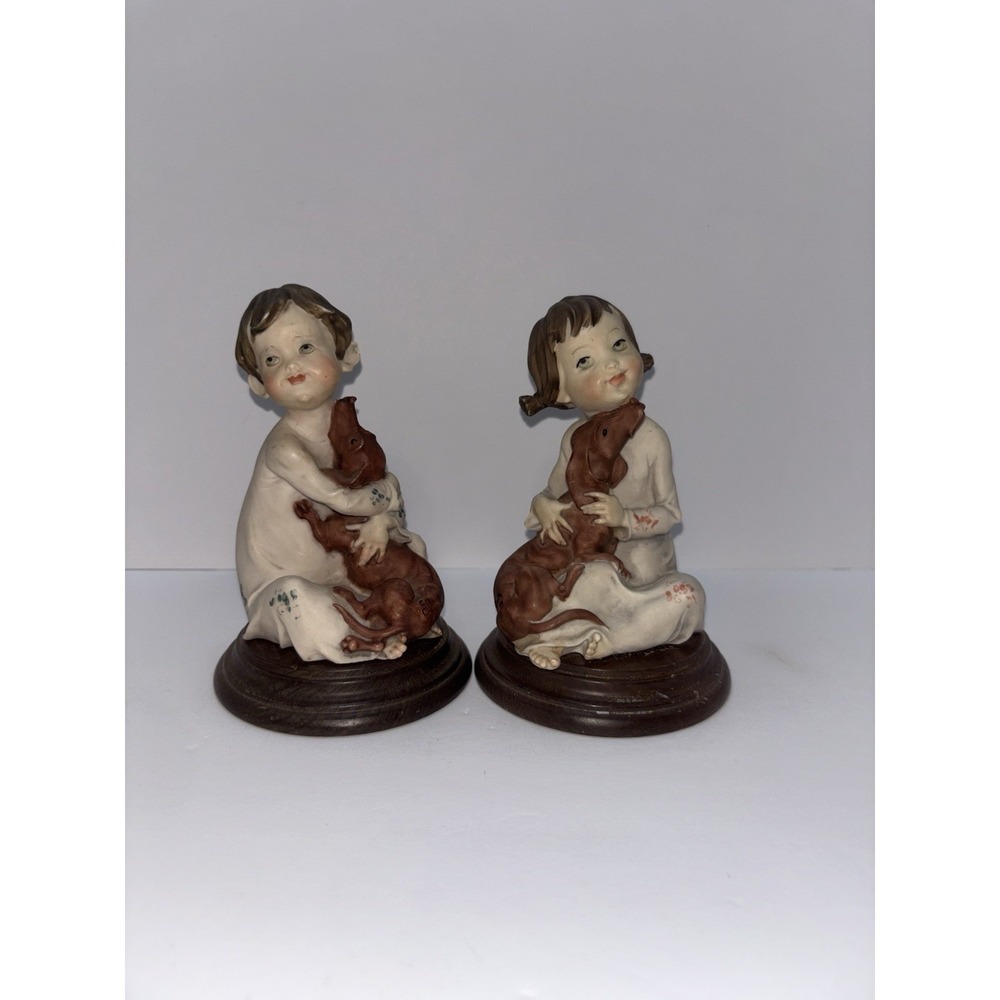 A Giuseppe Armani Porcelain Figurines of a girl & a Boy Holding a Dachshund
